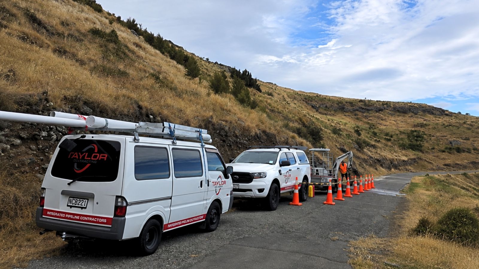 Taylor Plumbing Napier van, ute and mini excavator on a Hawke's Bay job site
